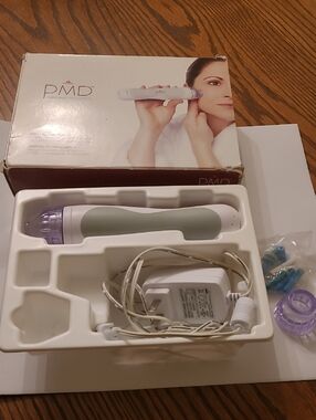 PMD Skincare Microderm Device in Sage Green, White and Purple